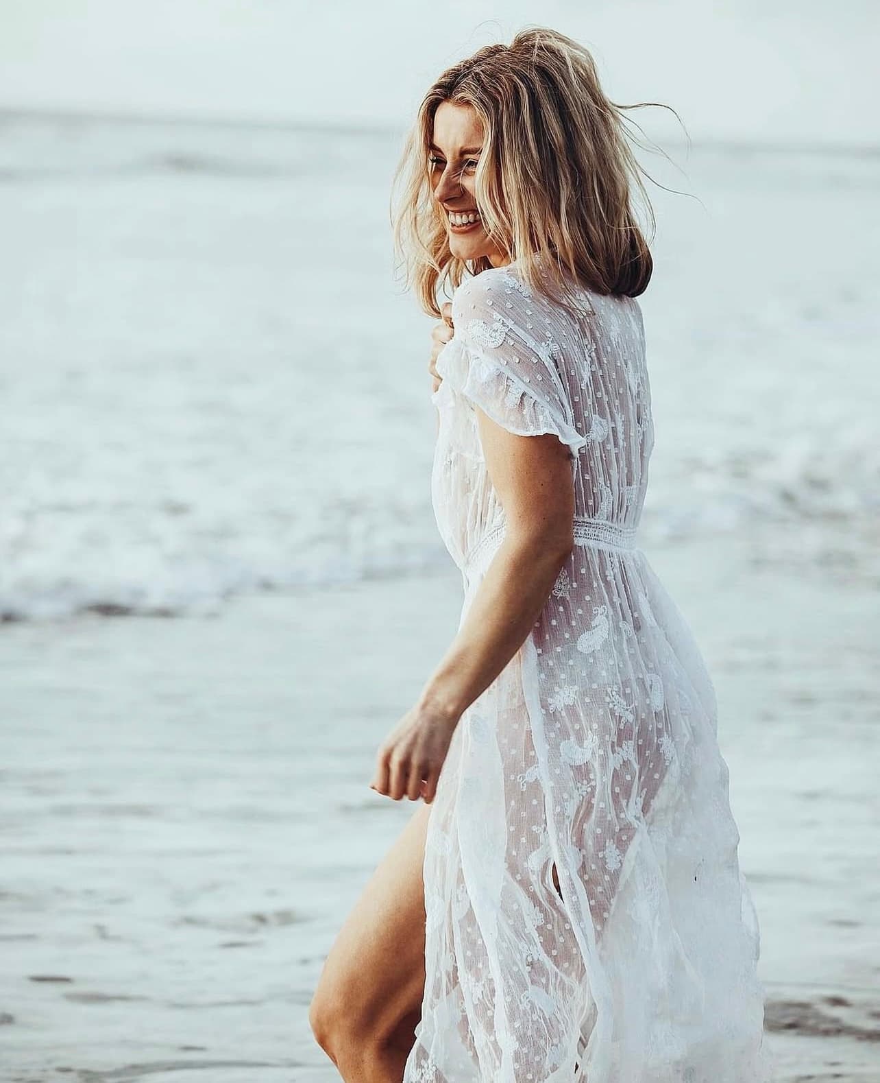 Leah walking on the beach laughing